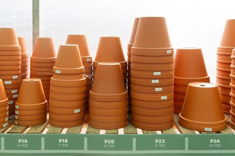Variety of sizes of clay flower pots on display in at Swanns Nursery garden centre, Suffolk,