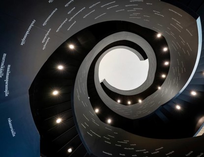 Spiral staircase printed with Finnish words, Oodi Central Library and Cultural Centre, designed by