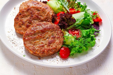 Fried cutlets, turkey, with vegetable salad, top view, no people