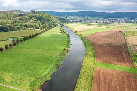 Aerial view over fields and meadows at the Weser river, east of village Wahmbeck, Weserbergland,
