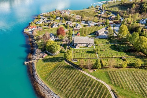 Aerial view of church and apple orchards, Ullensvang near Lofthus, Hardangerfjord, Norway, Europe