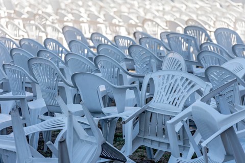 Seating for outdoor event, rows of chairs, overturned garden chairs made of plastic, plastic,