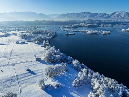 Aerial view of a lake in front of mountains, winter, snow, morning light, fog, Staffelsee, Alpine