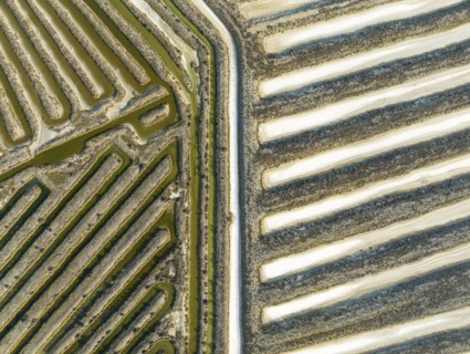 Saline ponds at the salt works near Chiclana de la Frontera. Aerial view. Drone shot. Cádiz