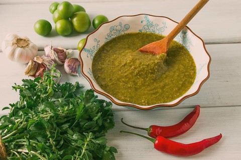 Tkemali sauce, traditional Georgian cuisine, green cherry plum, with ingredients for sauce,
