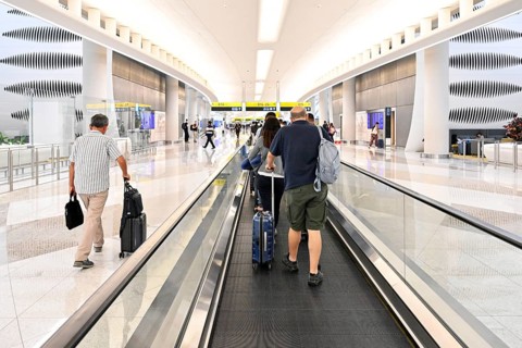 Airport transit tourists with luggage, Abu Dhabi, UAE