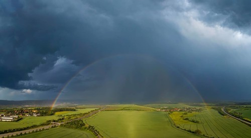 Thunderstorm cell with rainbow over fields near Krebs in the Osterzgebirge, Krebs, Saxony, Germany,