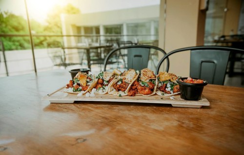Delicious Mexican chicken tacos with sauces served on table restaurant. Traditional tacos al pastor