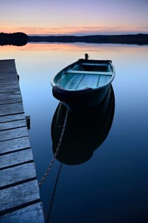 Quiet lake with jetty and rowing boat after sunset at dusk, Großer Lychensee, Lychen, Brandenburg,