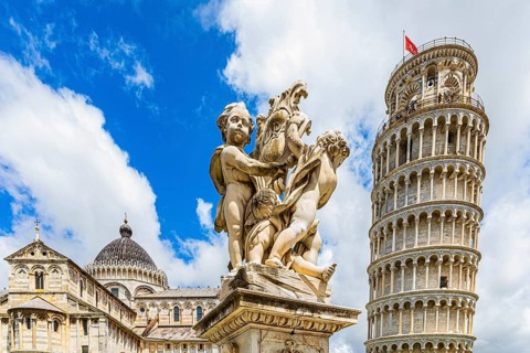 Statue of angels, behind the Leaning Tower and the Cathedral of Santa Maria Assunta, Pisa, Tuscany,