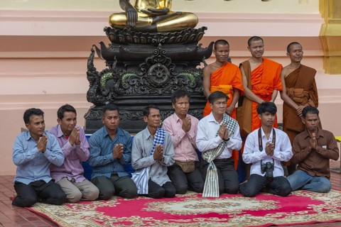 Monks and Laotians in front of a Buddha statue, Bhumispara-mudra, Buddha Gautama at the moment of