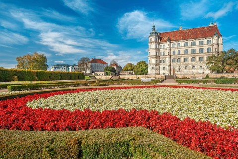 Güstrow Castle in autumn with colourful flower beds, built in the 16th century, Renaissance