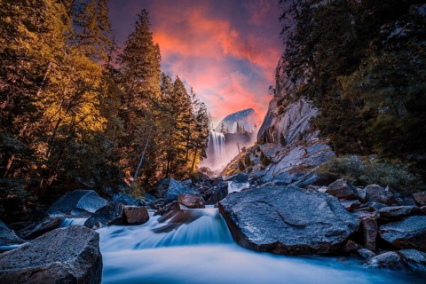 Sunset at Vernal Falls in Yosemite National Park in the water next to the stones, long exposure