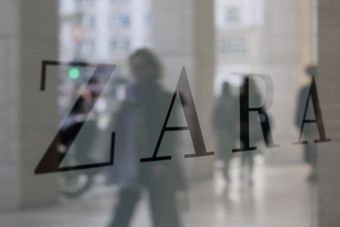 Company logo of the textile retail chain Zara, passers-by reflected in the shop window in Berlin,