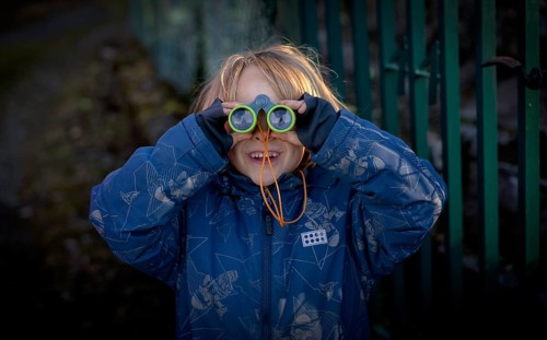 Little boy, 5 years, blond, looks through children's binoculars, toy, Stuttgart, Baden-Württemberg,