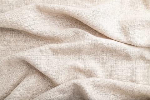 Fragment of white linen tissue. Side view, natural textile background and texture. wave concept,