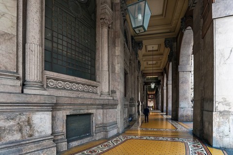 Arcaded walkway with mosaic floor from Palazzo della Borsa, built between 1907 and 1912, in Piazza