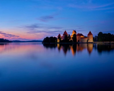 Evening view of Trakai Island Castle in lake Galve illuminated in the night, Lithuania, Europe