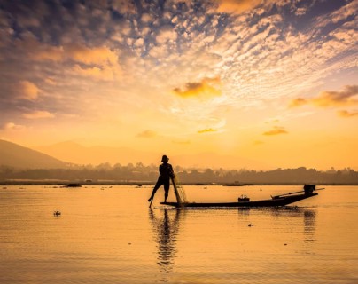 Myanmar travel attraction landmark, traditional Burmese fisherman sihouettes at Inle lake on