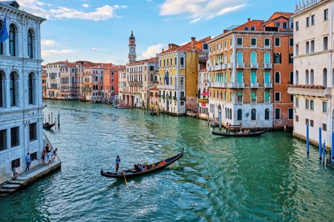 VENICE, ITALY, JUNE 27, 2018: Grand Canal with boats and gondolas on sunset, Venice, Italy, Europe