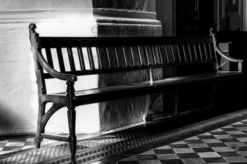 Black and white, wooden bench in the St. Mary's Church at Alexanderplatz, Berlin, Germany, Europe
