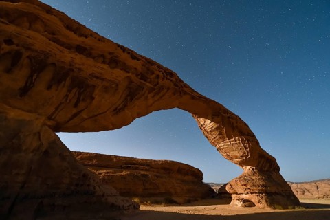 Starry sky above The Arch, also known as Rainbow Rock, near AlUla, Medina Province, Saudi Arabia,