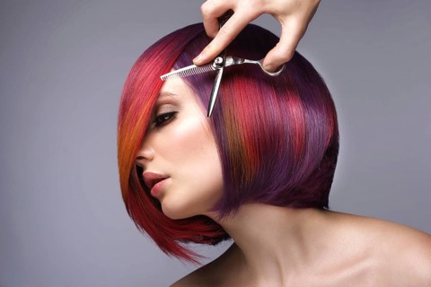Portrait of beautiful woman with multi-colored hair and creative make up and hairstyle