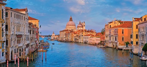 Panorama of Venice Grand Canal with boats and Santa Maria della Salute church on sunset from Ponte