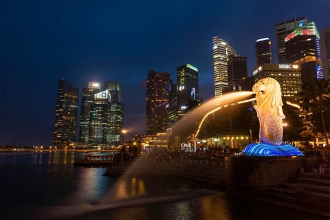 SINGAPORE, JANUARY 1, 2014: Night view of Singapore Merlion at Marina Bay against Singapore skyline