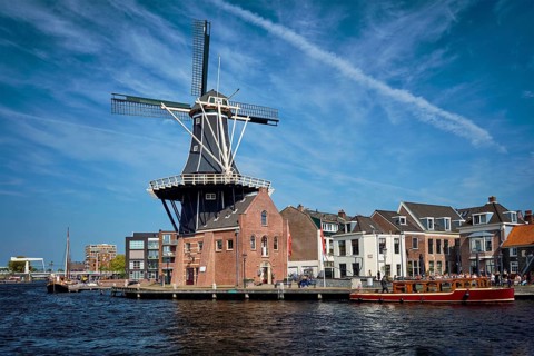 View of Harlem landmark windmill De Adriaan on Spaarne river. Harlem, Netherlands