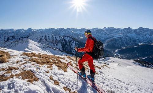 Ski tourers at the summit of Schafreuter, view of snowy mountain panorama, Karwendel, Tyrol,