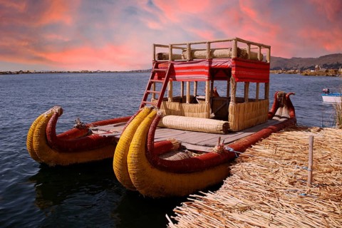 Boat used by people living on the island of Los Uros in Lake Titicaca, beautiful sunset, Peru,