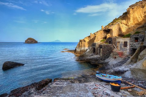 Houses in the rock, pebble beach, boat, sandstone rocks, Filicudi, Scoglio Faraglione, Spiaggia di