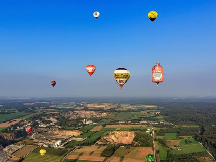 Many different hot-air balloons travelling in the blue sky, advertising, logo, hot-air balloon