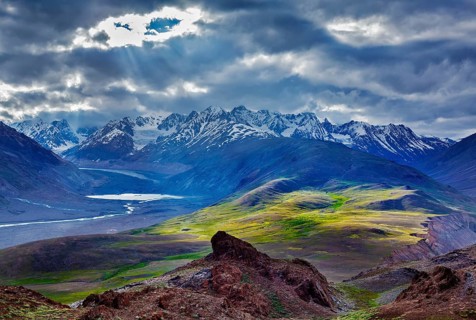 Himalayan landscape near Chandra Tal lake with sun rays coming through clouds. Himachal Pradesh,