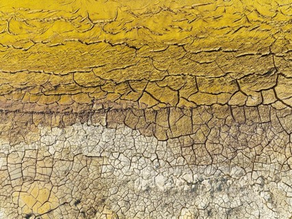 Mineral-rich cracked earth at the bank of the Rio Tinto (Red river), aerial view, drone shot,