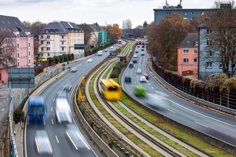 Motorway A40, Ruhrschnellweg, skyline of the city centre of Essen, exit Essen-Huttrop, track bus