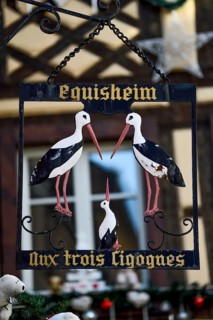 Sign at the restaurant Aux Trois Cigognes, Eguisheim, Département Haut-Rhin, Region Grand Est,