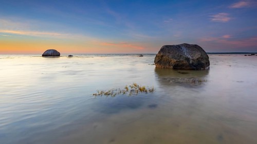 Large boulders on the beach of the Baltic Sea at sunset, Wismar Bay, Baltic Sea,