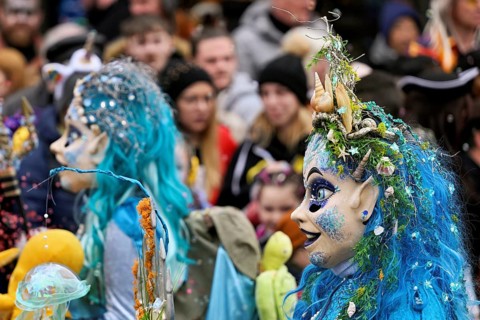 Person masked as Meerjugfrau at the carnival parade of the Wey guild on Rose Monday, Güdismäntig,