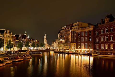 Historic buildings and mint tower illuminated at night, Singelgracht, Amsterdam, North Holland,