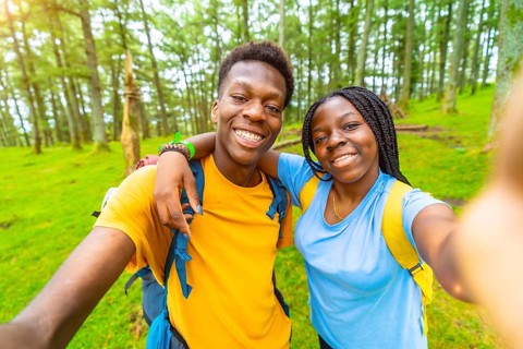 African friends during selfie moment while hiking in the forest