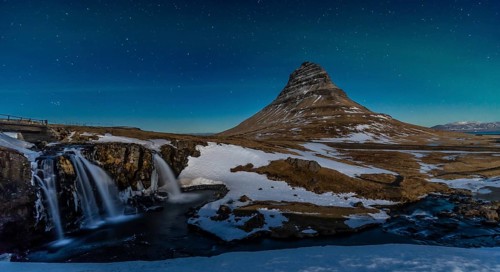 Long exposure panorama of the picturesque Kirkjufell mountain at night in winter in Iceland