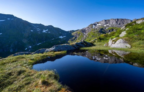 Mountains reflected in a lake, hike to the summit of Rundfjellet, Svolvaer, Nordland, Norway,