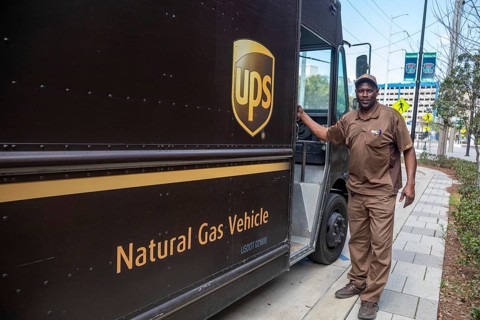 New Orleans, Louisiana - A United Parcel Service driver and his natural gas powered 'package car'