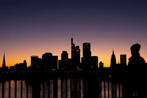 The silhouette of Frankfurt's banking skyline stands out in the evening against the residual light