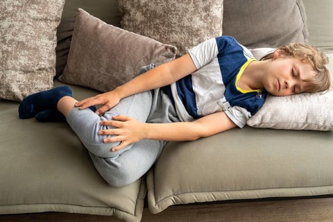 Growing pains in children, boy, 10 years old, has pain in his leg, symbolic picture