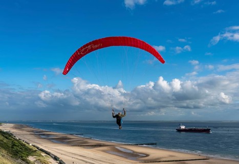 Paragliders along the dunes of Zoutelande, in Zeeland, South Holland, Netherlands