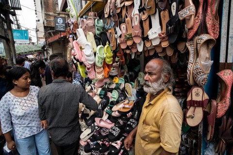 A vendor sells shoes and sandals at a street market ahead of Durga Puja festival on October 7, 2024