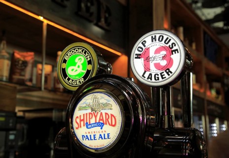 Bar beer signs different beers at Wetherspoons bar, Stansted airport, Essex, England, UK